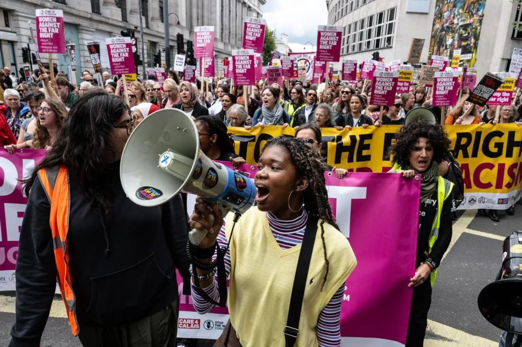 A protester holding a megaphone at a Stand Up To Racism anti-racist demonstration